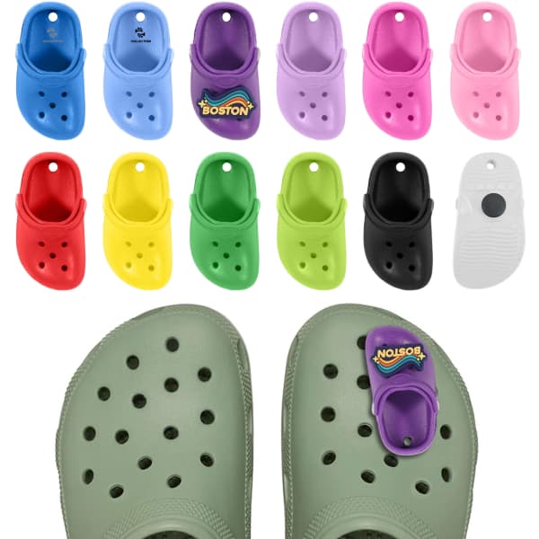 Clog shoe shaped charms in various colours, including pink, blue, green, black, and a purple charm with a logo.