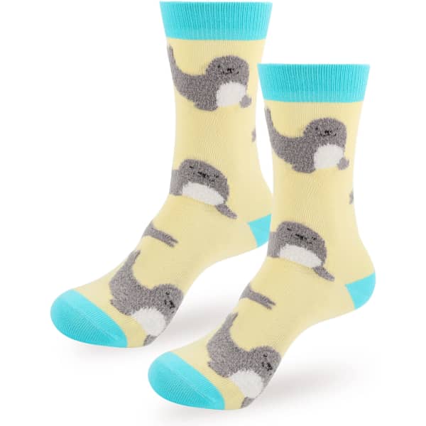 Woven socks featuring a playful design of grey and yellow narwhals on a light yellow background with turquoise accents.