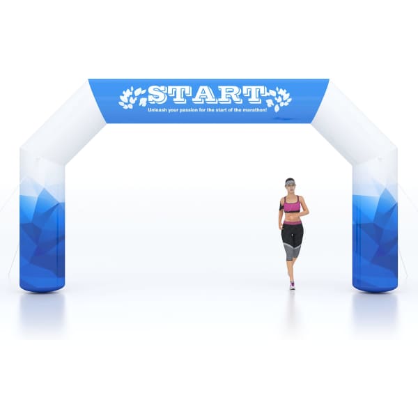 A large inflatable arch in blue and white, featuring a logo, with a runner passing through it.