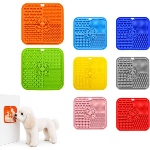 A collection of four-section dog enrichment lick mats in orange, blue, yellow, grey, red, and pink. Each mat features various textured sections and has a logo.