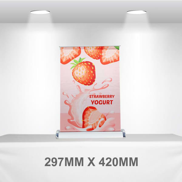 A pull-up banner featuring a pink design with strawberries and yogurt imagery. It includes a logo at the bottom.
