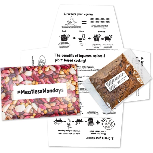 A set featuring a colourful pouch of spices and instructional cards on cooking with legumes and plant-based recipes.