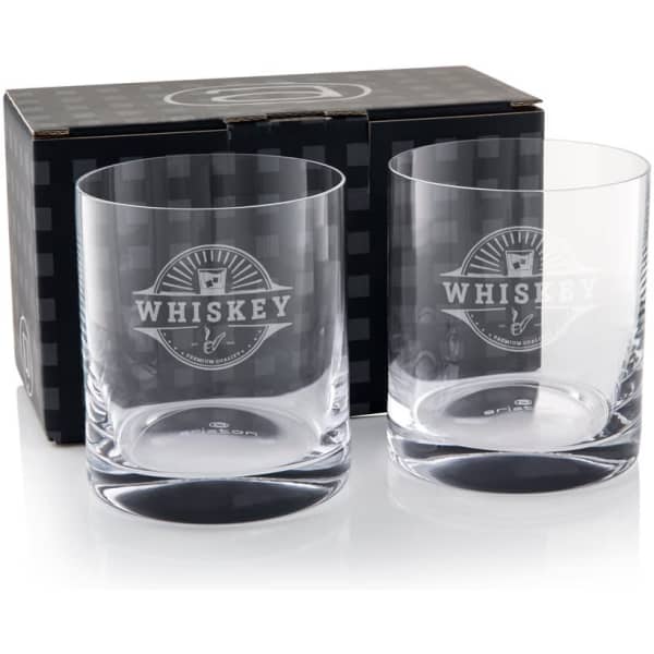 Two clear glass whisky tumblers packaged in a black box featuring a logo.