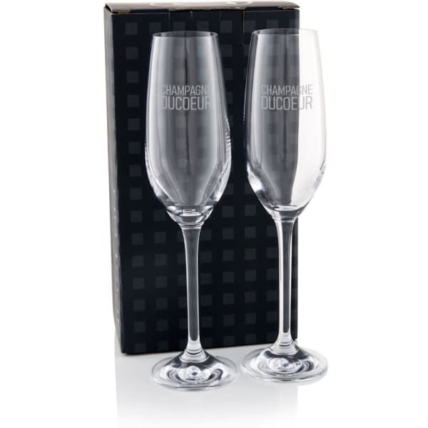 A twin pack of clear champagne flutes in a black box, featuring elegant stemware design and branding.