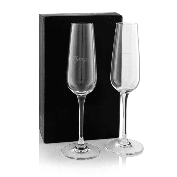 A twin pack of elegant glass flutes, clear glass with tall stems, presented in a black gift box.