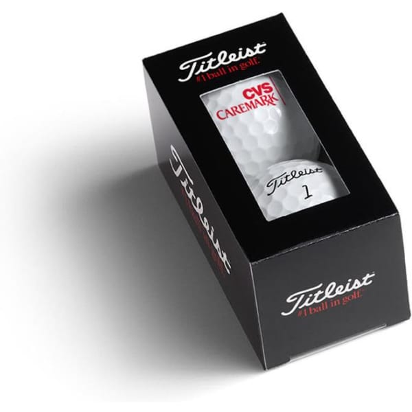 A black box containing two white golf balls, featuring a logo and red accents.