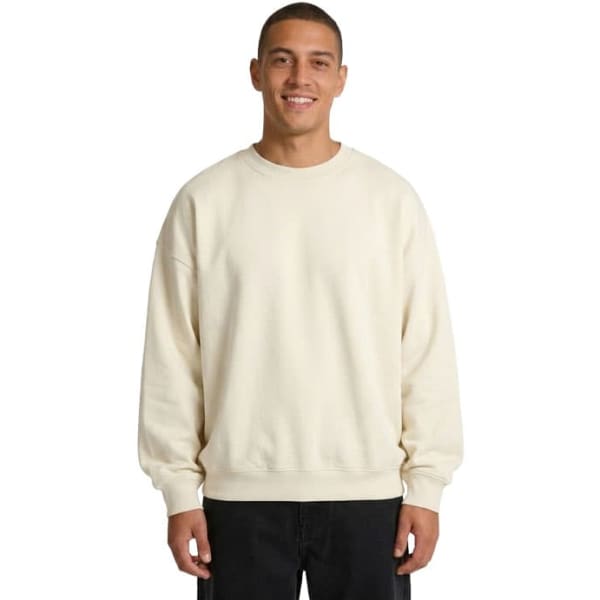 A beige oversize crew neck fleece jumper featuring dropped shoulders and a relaxed fit. It includes a logo on the label.