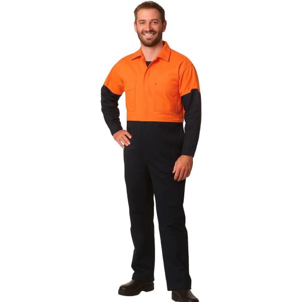 A man is wearing a Hi-Vis two-tone cotton drill coverall, featuring orange and navy blue colours. It has a logo.