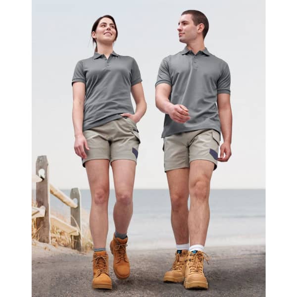 A pair of unisex cotton stretch drill short work shorts in light grey, worn by a male and female model.