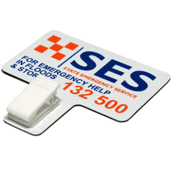 A rectangular magnet with a white background, featuring blue and orange text and a clip for attachment.