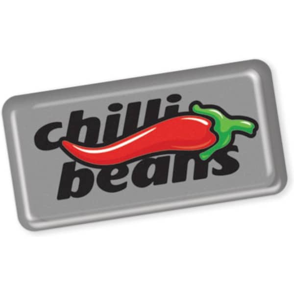 A rectangular resin-coated label featuring a red chilli pepper graphic and black text on a metallic grey background.