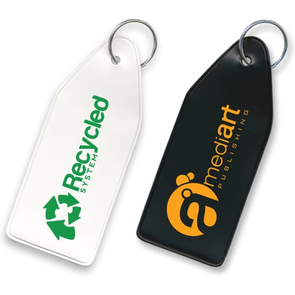 A black and white vinyl key tag featuring circular ring attachments and logos on each side.
