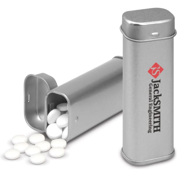 A silver tin container with a lid, filled with white mint tablets. The tin features a logo.