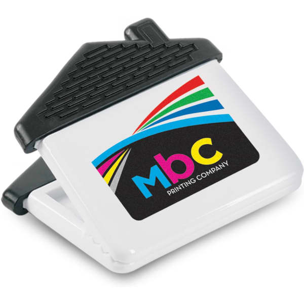A white magnetic clip shaped like a house with a black top and a multicoloured logo.