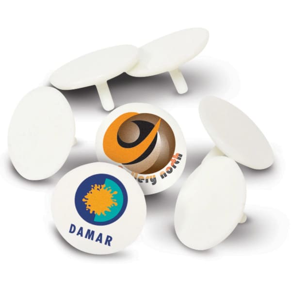 A set of white plastic golf ball markers featuring logos on some markers and a simple design.