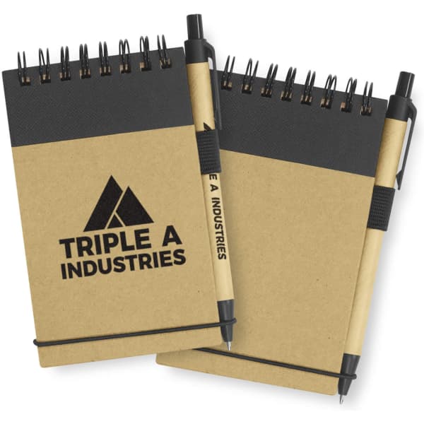 A Spiro Notebook in natural brown with a black top section, accompanied by a black pen and featuring a branding logo.