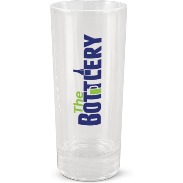 A clear shot glass featuring a logo, with a tall and slim design. The glass is transparent with a smooth finish.
