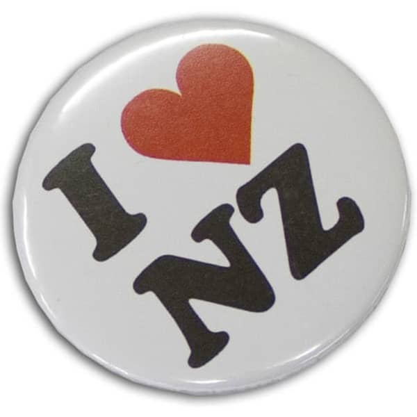 A round, 37mm button badge featuring black text and a red heart on a white background, with a logo present.