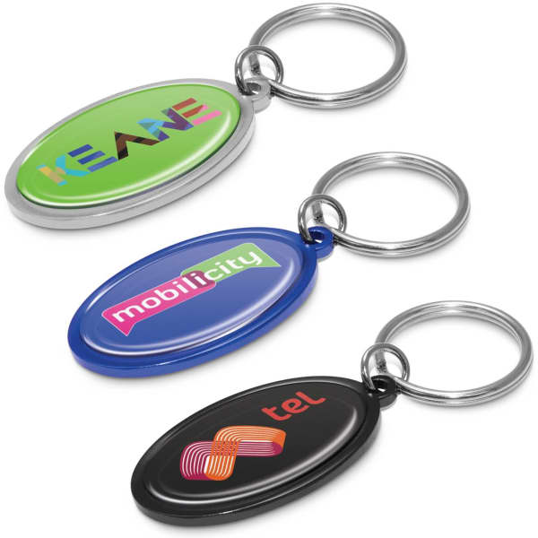 Three oval key rings in green, blue, and black, each featuring different logos and a silver metal keyring.