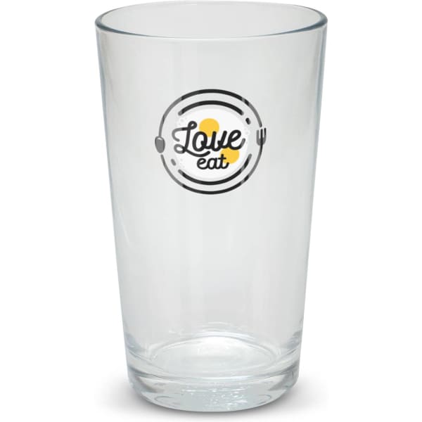 A clear glass tumbler featuring a circular design with the words 
