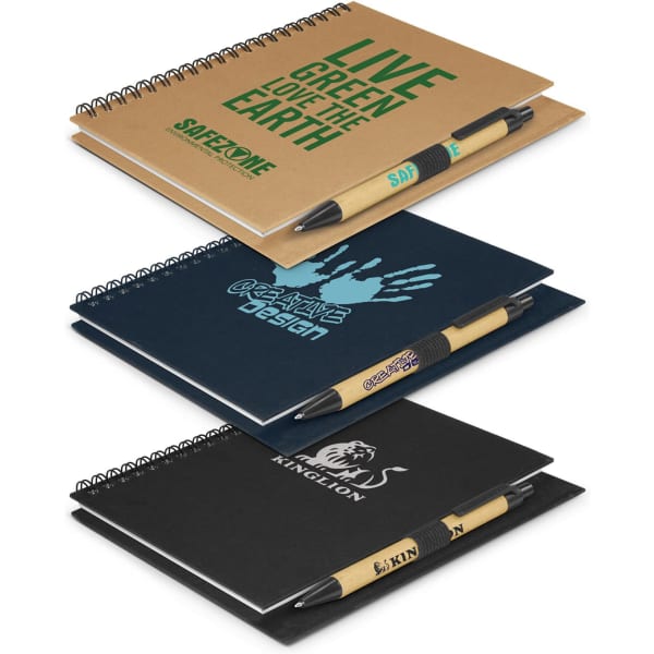 Three assorted notebooks in brown, black, and blue with pens, featuring different designs and a logo on each cover.