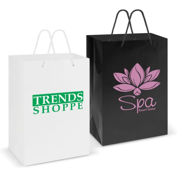 Two large laminated carry bags are displayed: one white with green branding and the other black with pink branding.