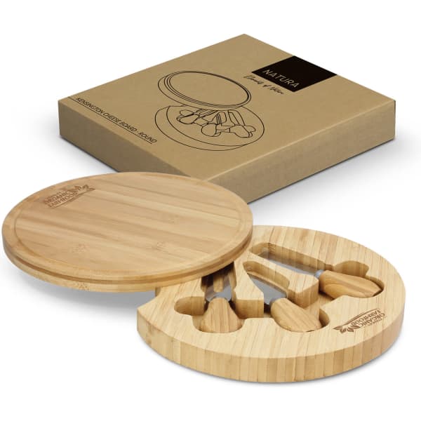 A round bamboo cheese board with three knives, presented in a kraft box. The board features cutouts for the utensils.