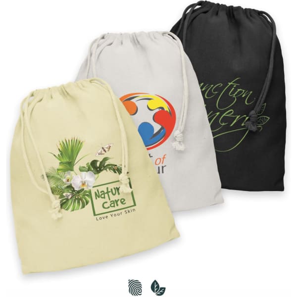 Three large cotton gift bags in yellow, cream, and black, featuring logos and drawstring closures.
