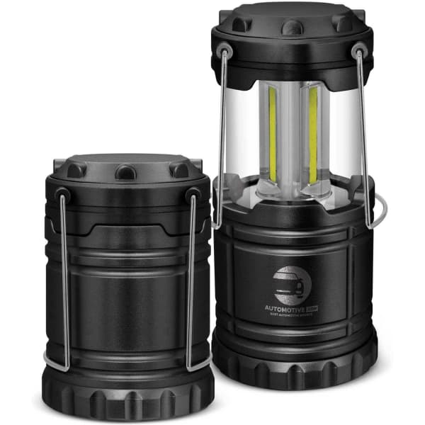 A black COB lantern with a clear casing, featuring a collapsible design and handle for easy portability.