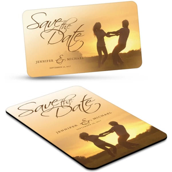 A rectangular fridge magnet featuring a sunset scene with two dancers, in warm colours, with a logo.