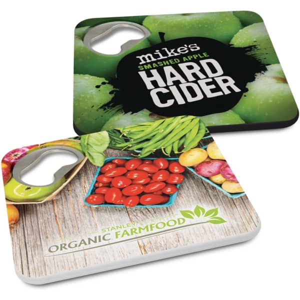 A drink bottle opener coaster featuring vibrant green apples and assorted vegetables with a logo on one side.