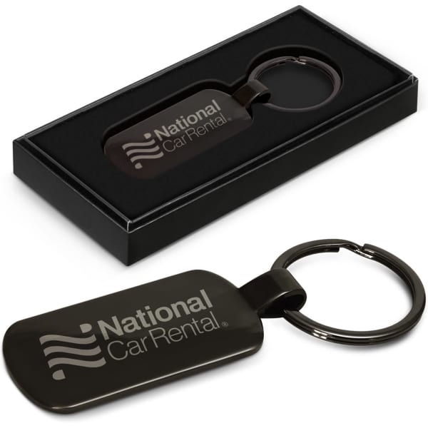 A black key ring in a sleek black box, featuring a logo on the surface.