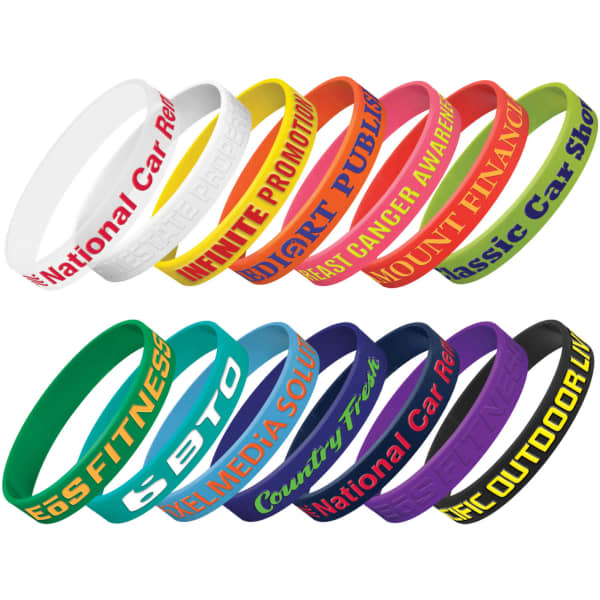 A collection of silicone wristbands in various colours, featuring embossed text. Some include logos or branding elements.