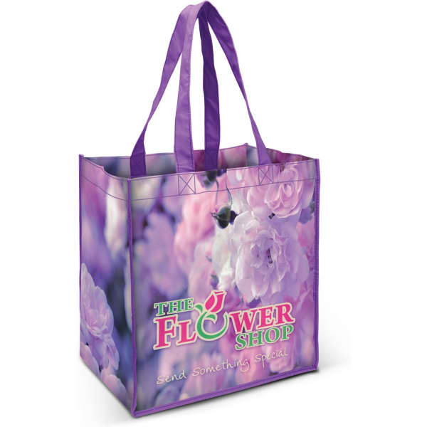 A purple tote bag featuring floral designs and a logo. The bag has sturdy handles and a spacious interior.