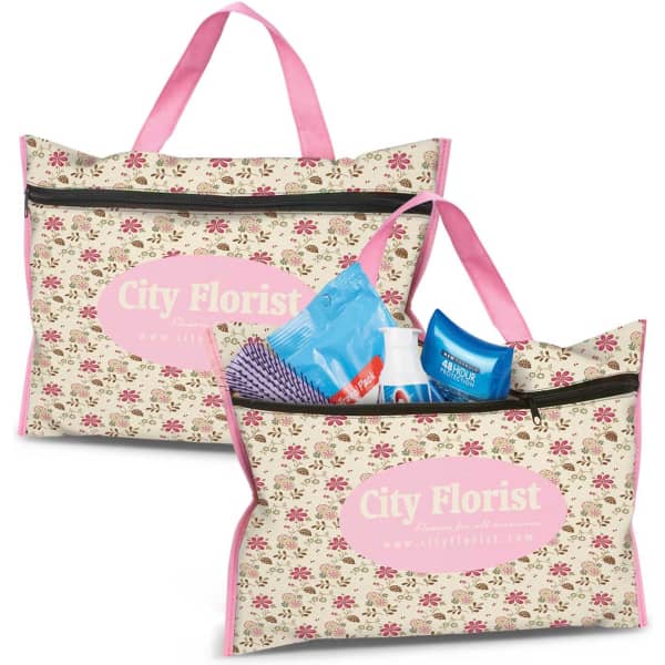 A floral-patterned toiletry bag in cream and pink, featuring handles and a zip closure, with various toiletries inside.
