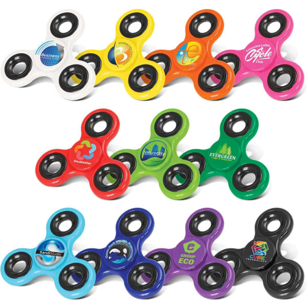 A collection of fidget spinners in various colours, featuring multiple designs and logos, arranged in rows.