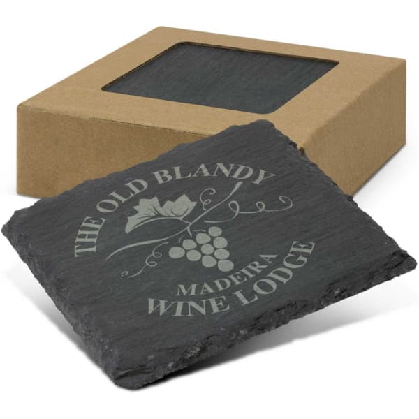 A set of four grey slate coasters, packaged in a brown box with a clear window, featuring a logo engravement.