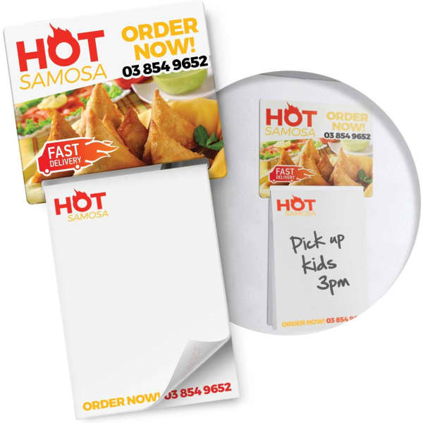 A magnetic memo pad in full colour featuring a logo, with a notepad and a sticky note showing handwritten text.