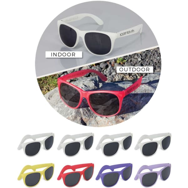 A variety of Malibu Basic Sunglasses in white, red, yellow, and purple on a grey background and rocky surface.