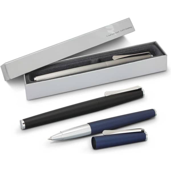 A Lamy Studio Rolling Ball Pen set in black, silver, and blue, displayed in an elegant silver box.