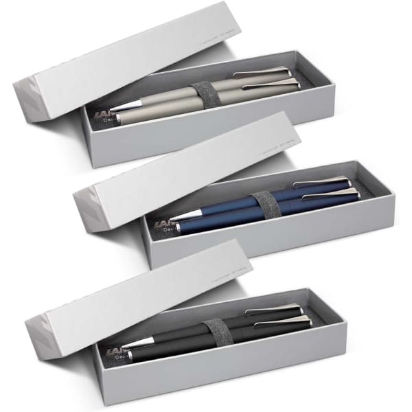 A pen set featuring three metal pens in grey, navy, and black packaging inside a grey box with a logo.