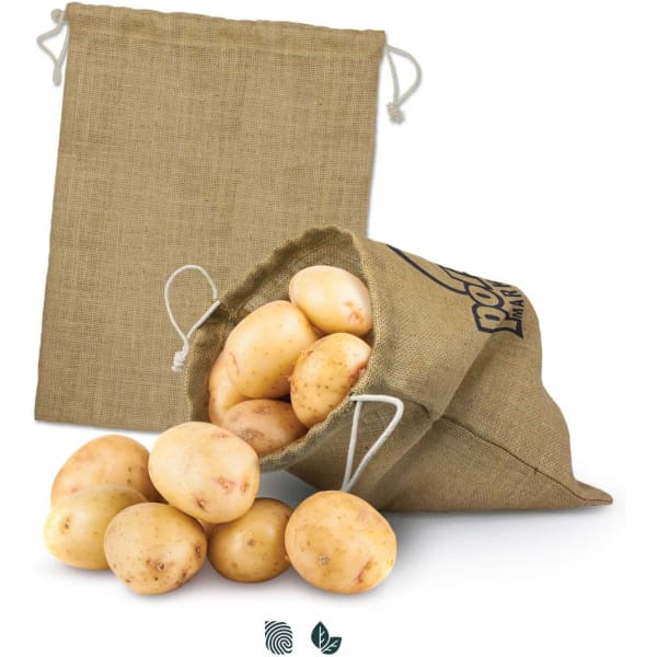 A large jute produce bag in beige, filled with fresh potatoes, with another empty bag in the background.