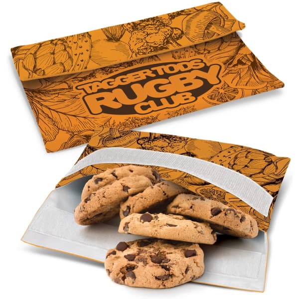 An orange reusable snack pouch features a patterned design and holds chocolate chip cookies inside. It has a logo.