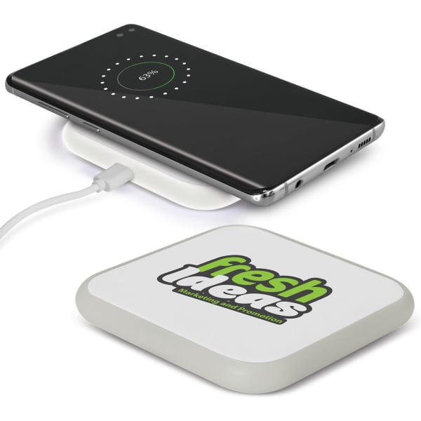 A square wireless charger in white with a logo, featuring a smartphone charging on top.