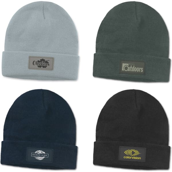 Four beanies in light grey, dark green, navy blue, and black, each featuring a different logo or patch.