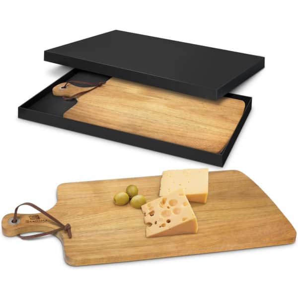 A wooden serving board with a leather handle and packaged in a black box, featuring cheese and olives.