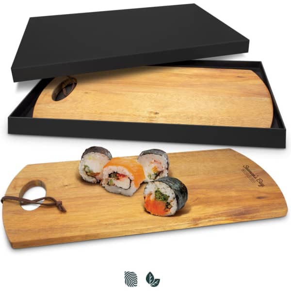 A wooden serving board with a natural finish, featuring sushi, presented in a black gift box.