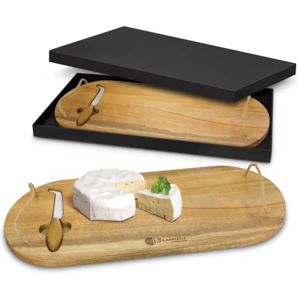 A wooden cheese board presented with a knife, featuring a black box packaging. The board has a natural finish.
