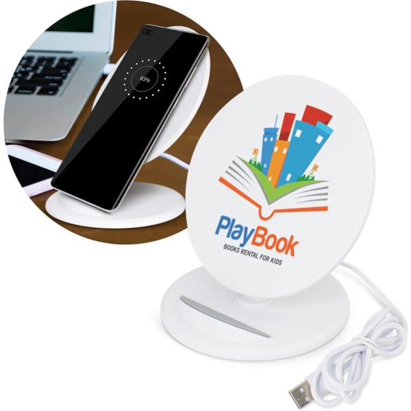 A round white wireless charging stand with a logo, accompanied by a smartphone charging on it.