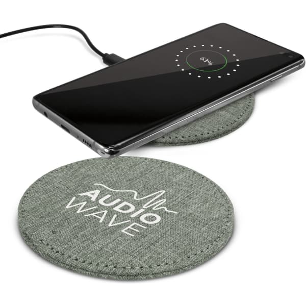 A green fabric wireless charger with a phone placed on top, displaying a charging indicator. It has a logo.